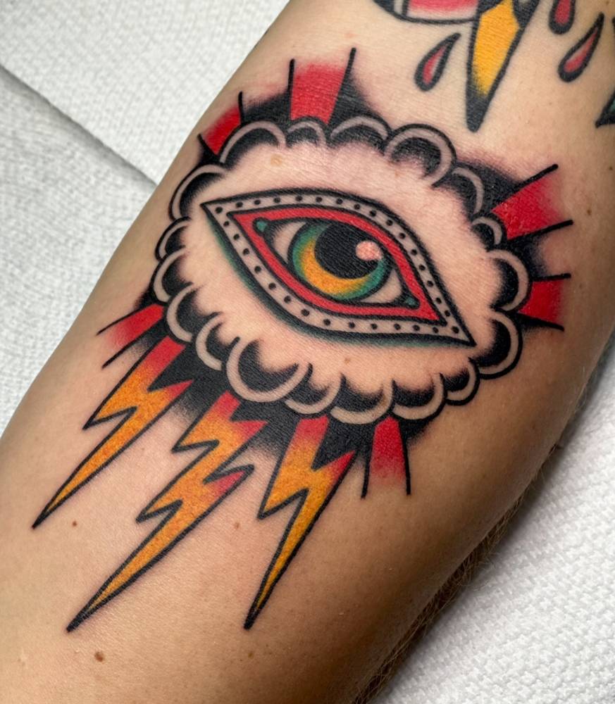Eye, cloud and lightning bolts tattoo in traditional style.