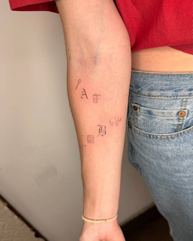 Single needle mini tattoos located on the inner forearm.
