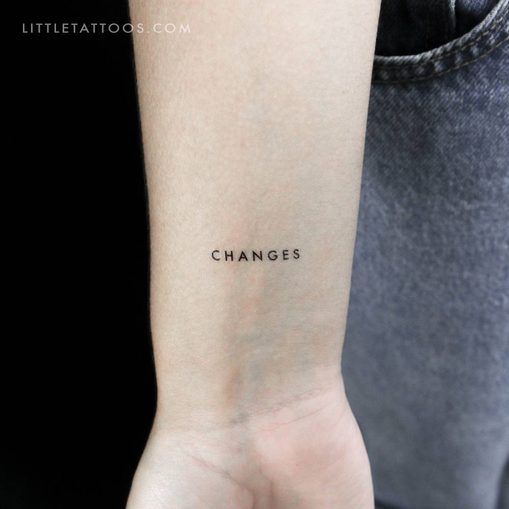 Word "changes" temporary lettering tattoo located on the wrist.