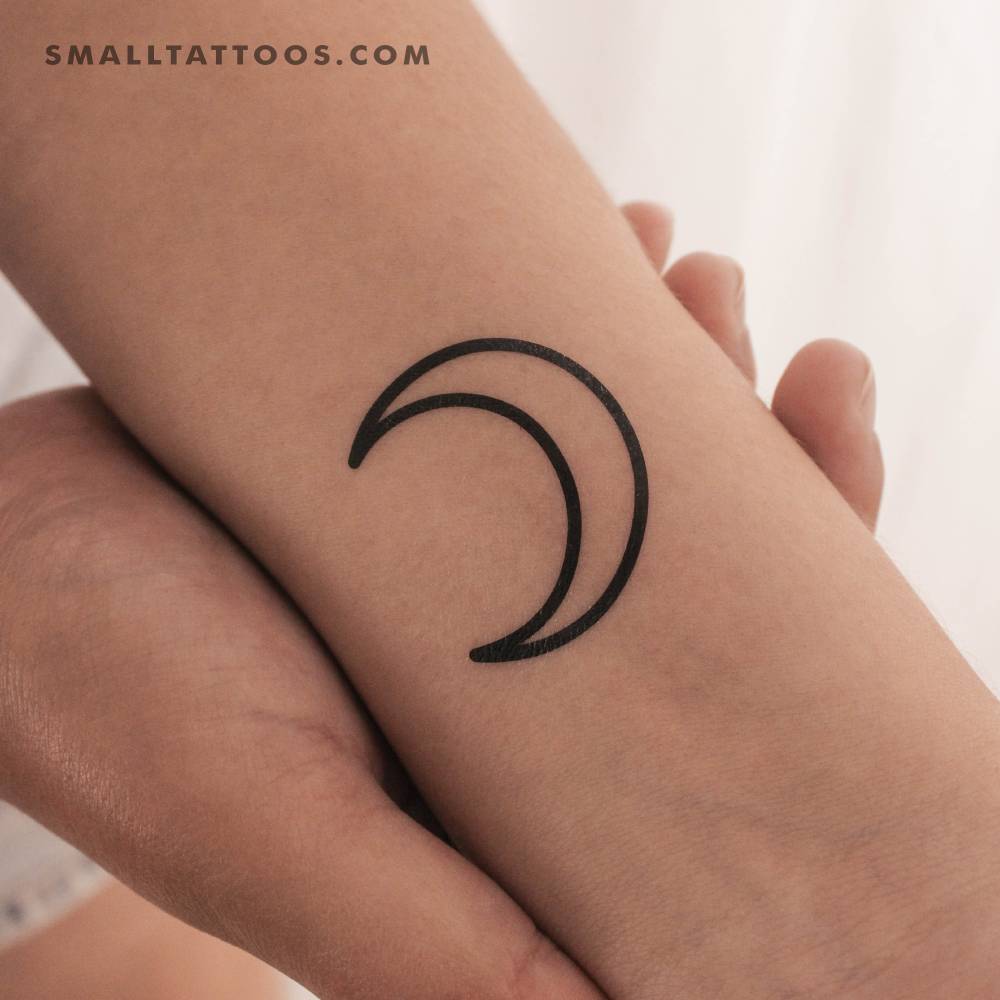 Crescent outline temporary tattoo placed on the wrist.