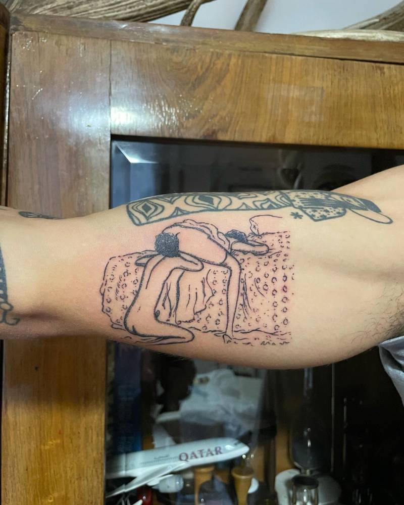 Oral sex tattoo located on the inner arm, blackwork style.