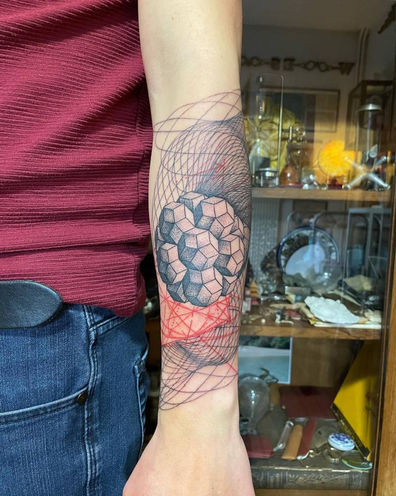 Graphic style geometric design tattooed on the forearm.