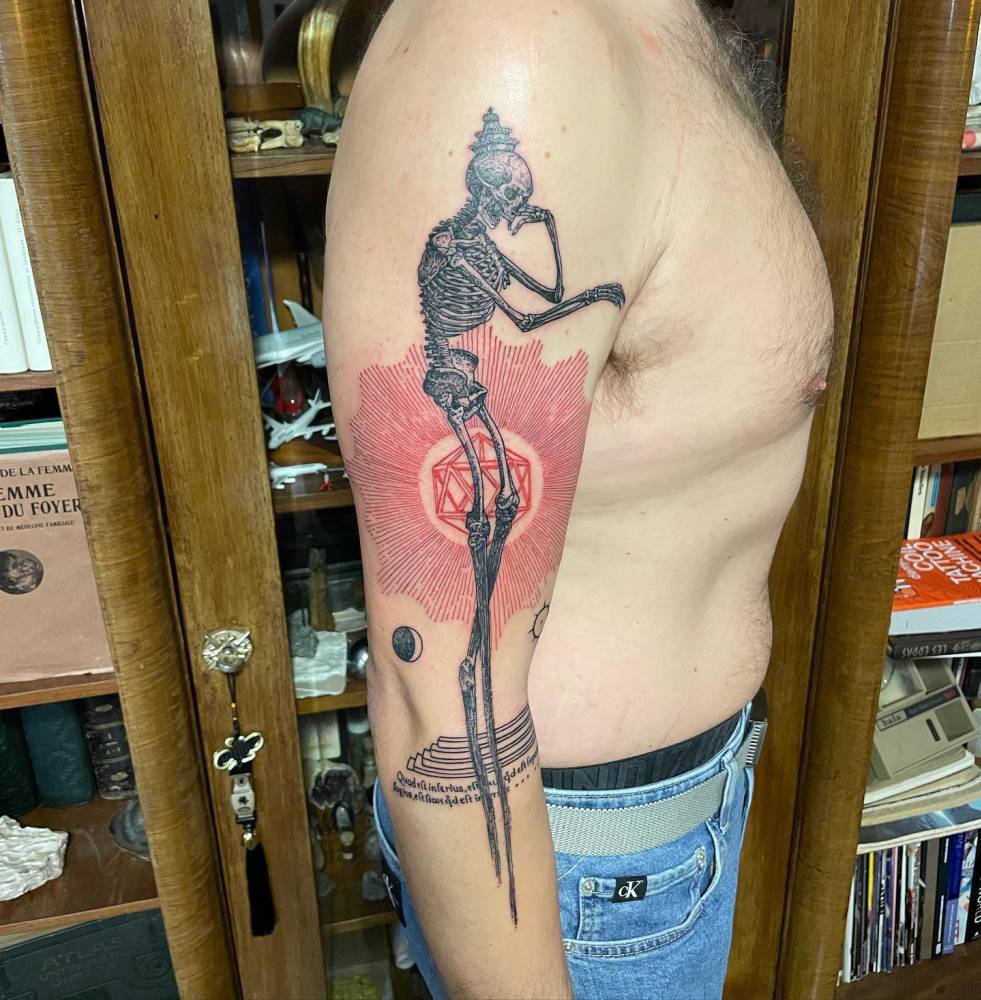 Skeleton tattoo located on the arm, done in graphic style.