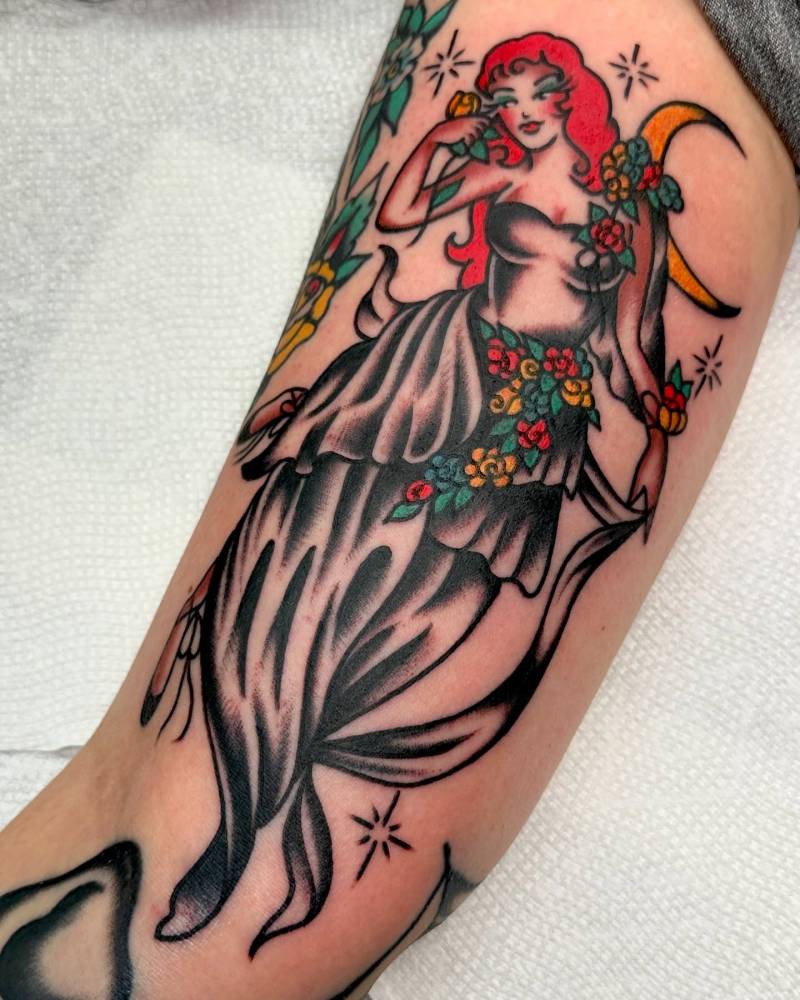 Woman tattoo in traditional style located on the inner arm.