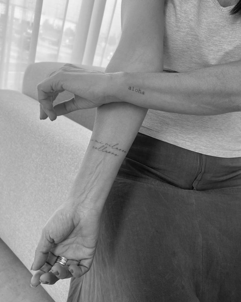 Little word "aloha" and Italian quote lettering tattoos.
