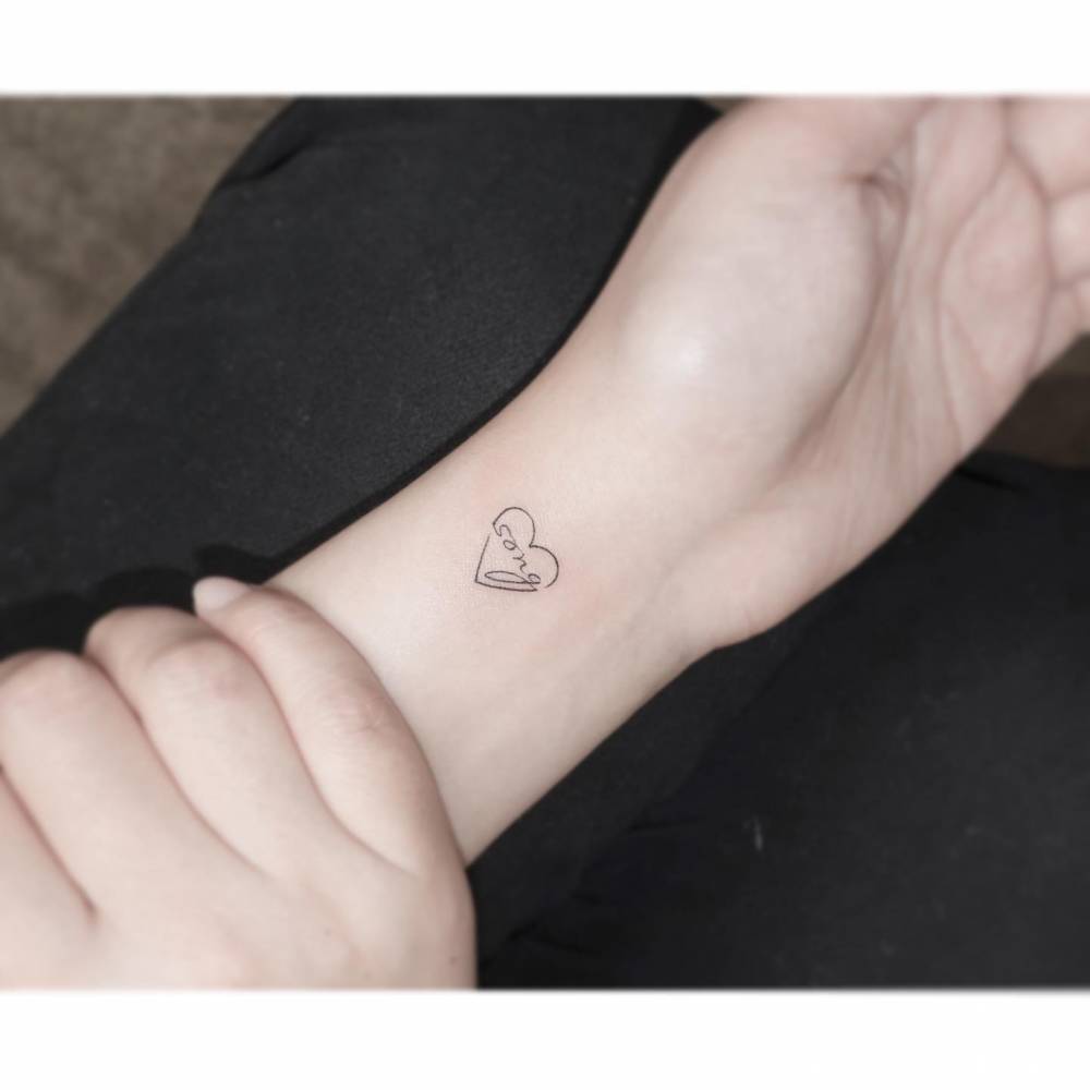 Heart and banner with the name "Song" tattooed in minimalistic style.