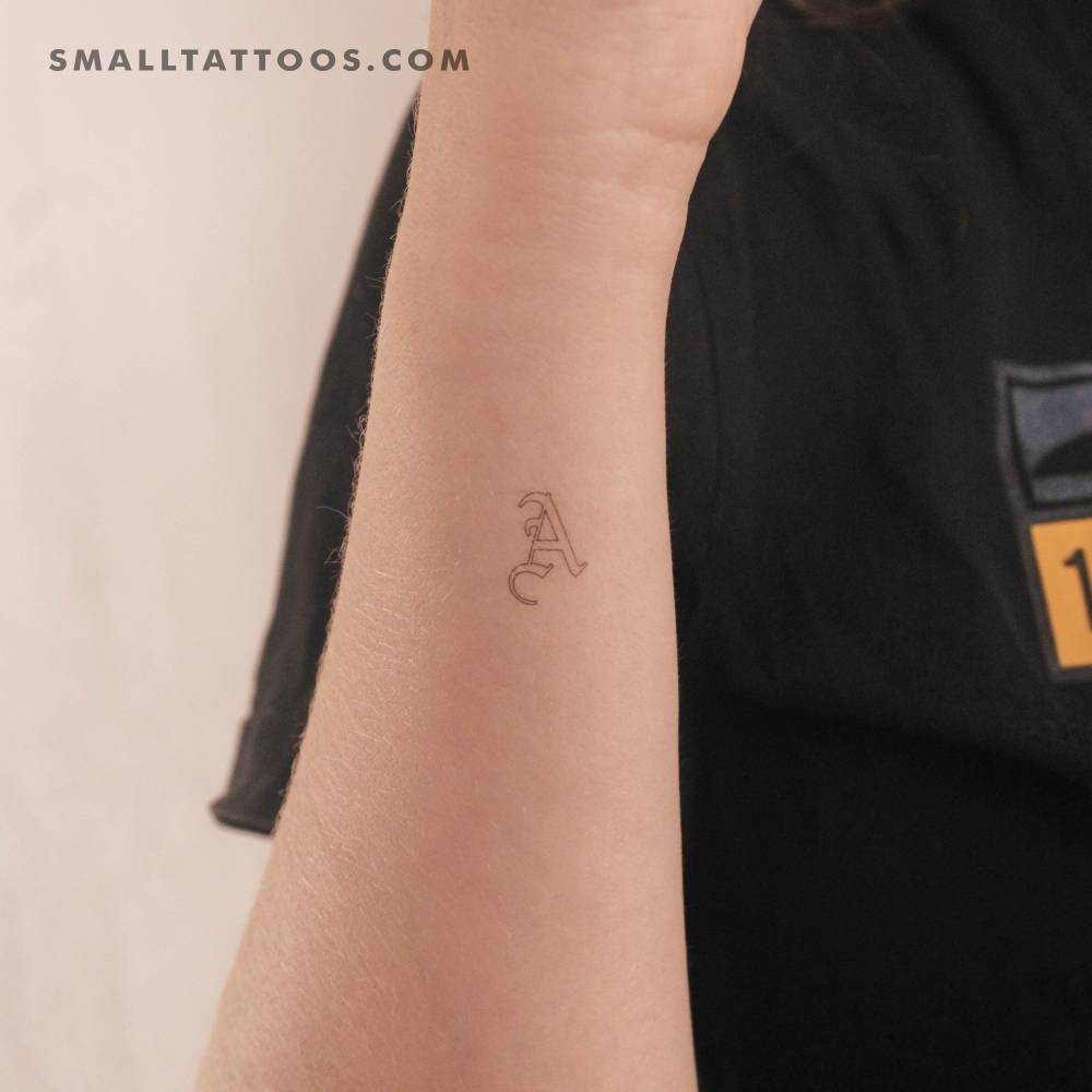 Old English "A" letter temporary tattoo located on the wrist.