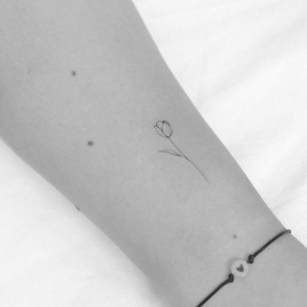 Single needle tulip tattoo done on the wrist.