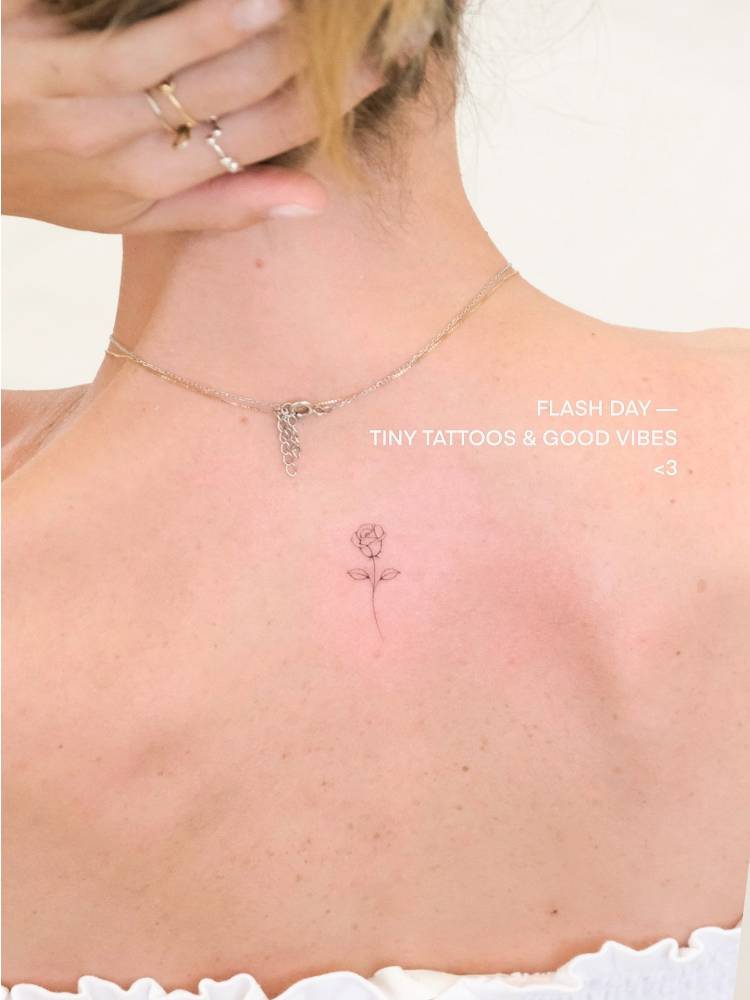 Little rose tattoo in fine line style located on the upper back.