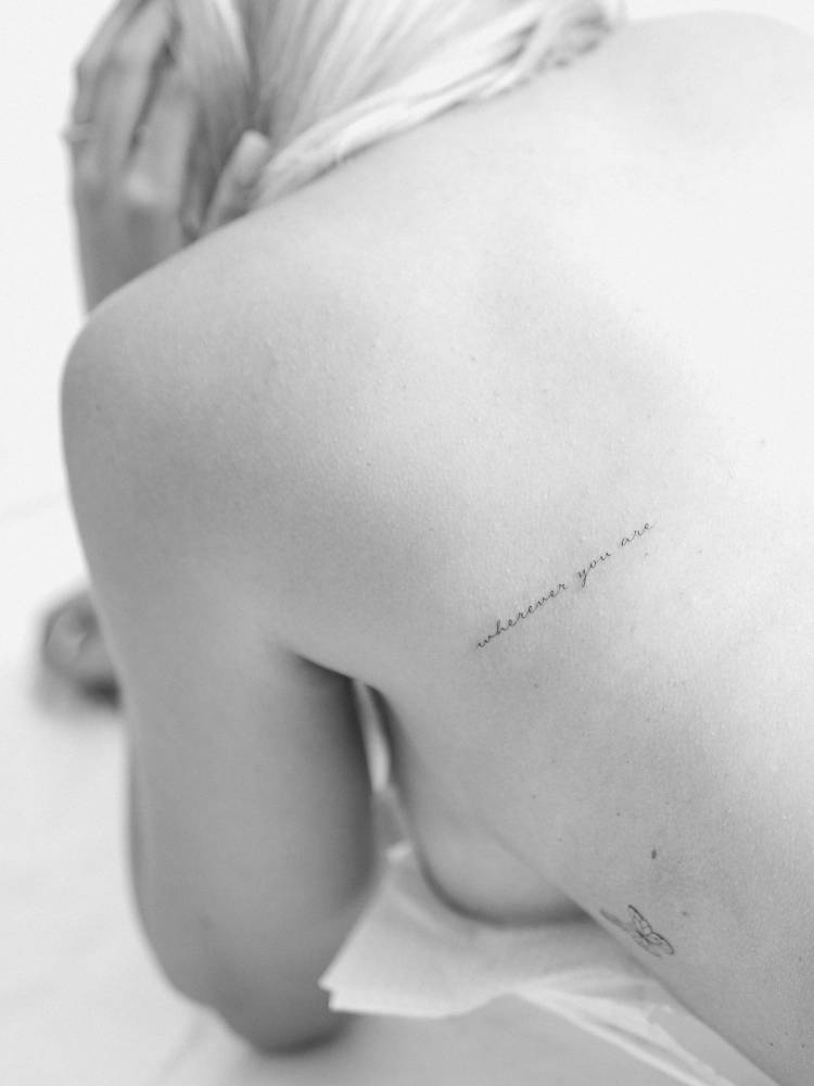 Handwritten font lettering tattoo that says "wherever you are".