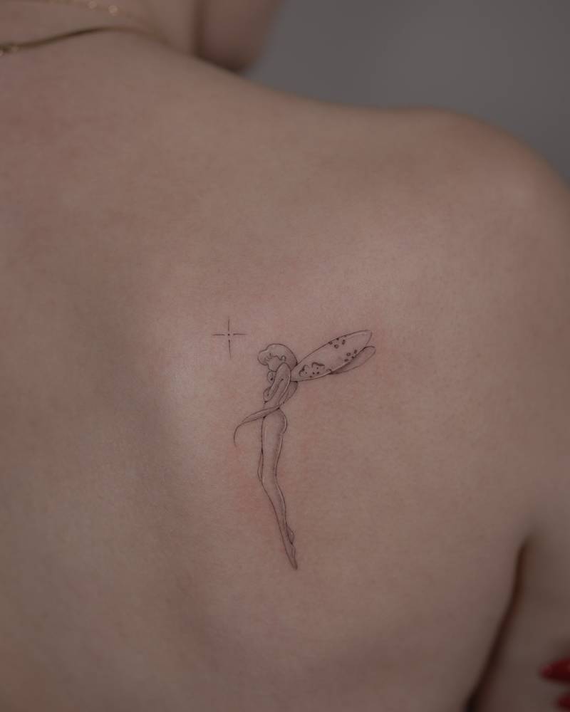 Single needle fairy tattoo located on the shoulder blade.