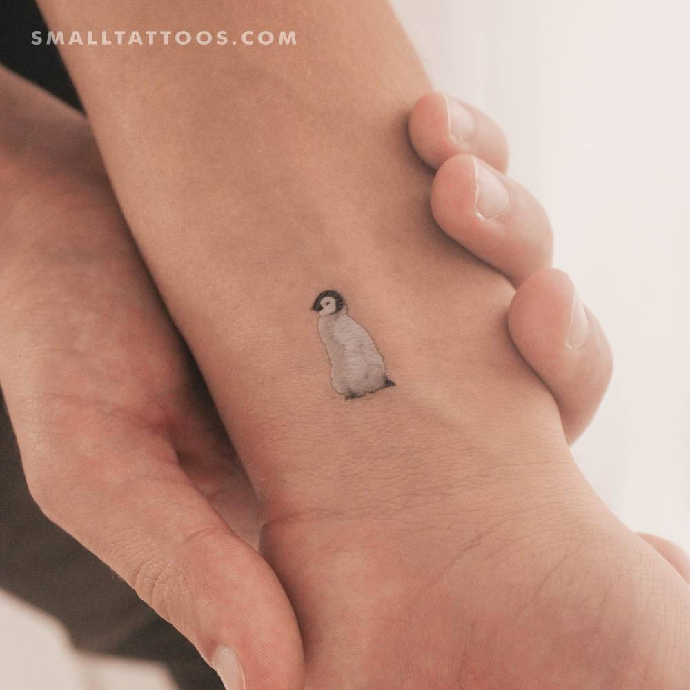 Baby penguin temporary tattoo located on the wrist.
