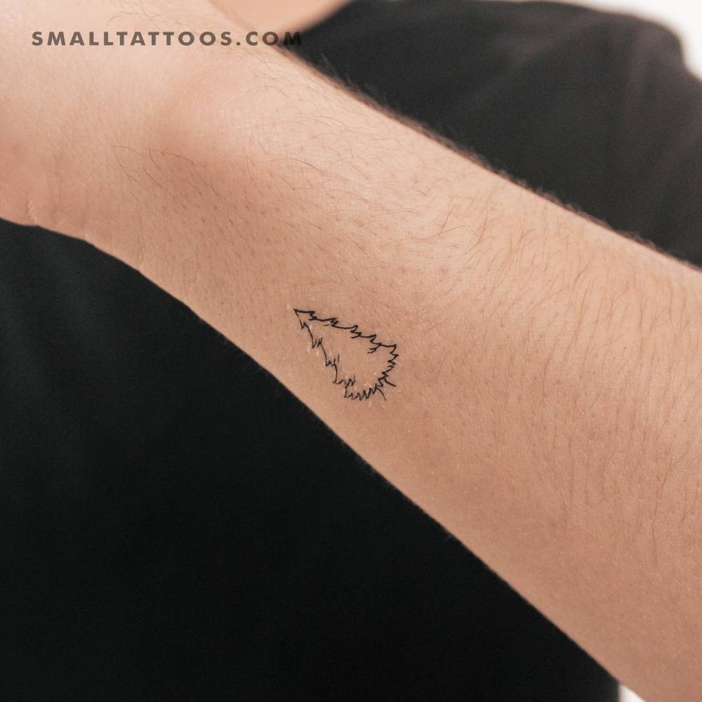 Fine line pine tree temporary tattoo located on the wrist.