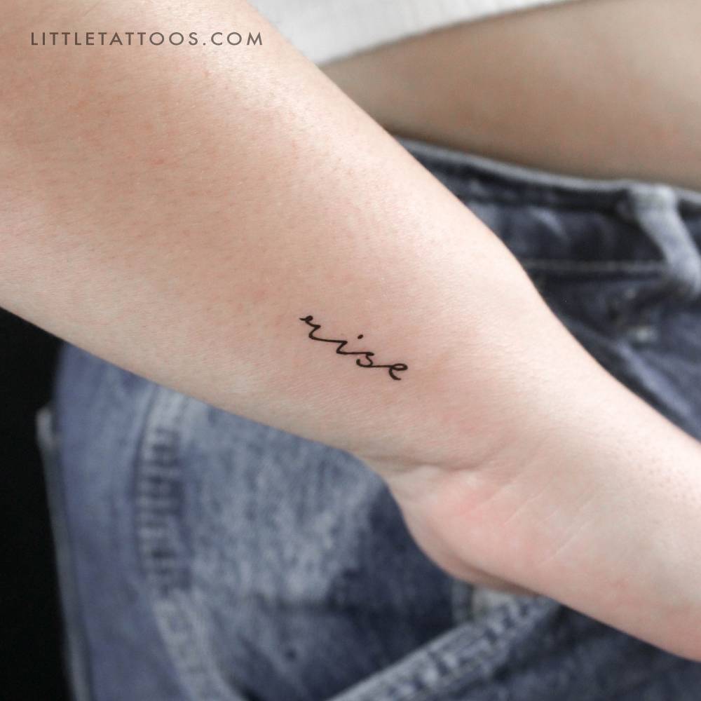 Handwritten font word "rise" temporary tattoo located on the wrist.