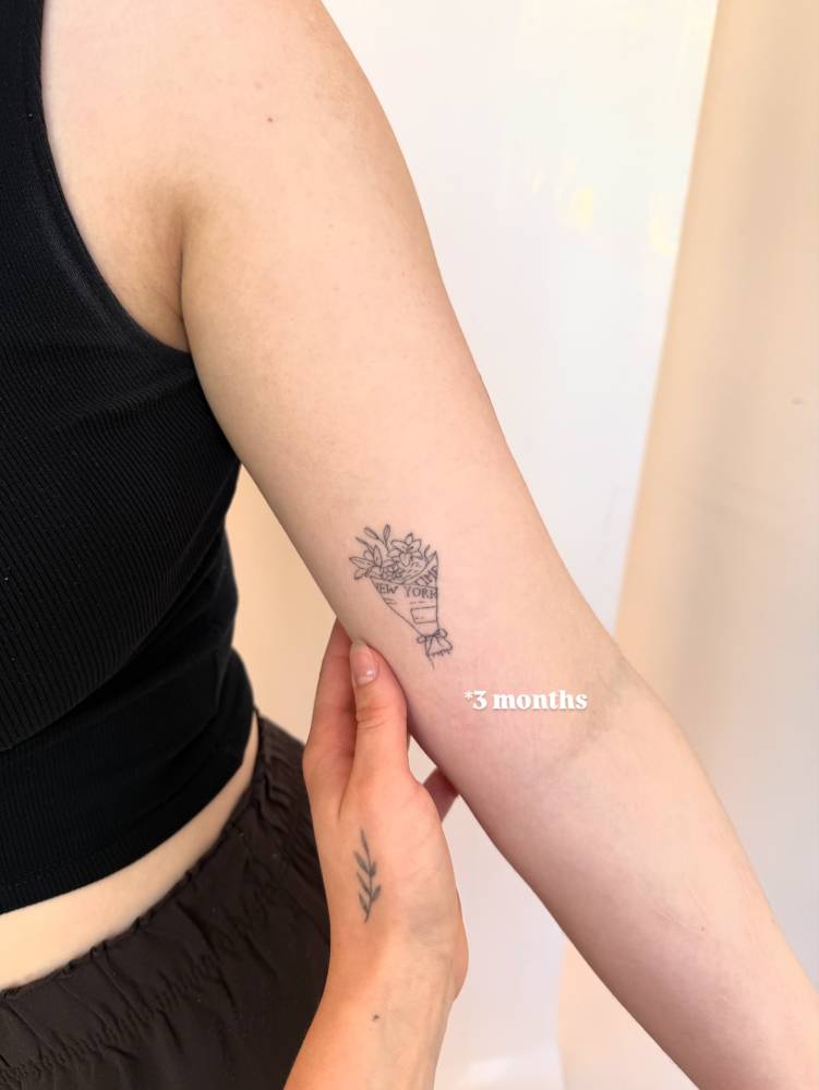 Flower bouquet tattoo in fine line style located on the inner arm (3 months healed).