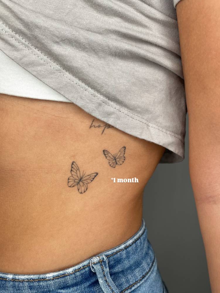 Butterfly couple tattoo done on the rib, fine line style (healed).