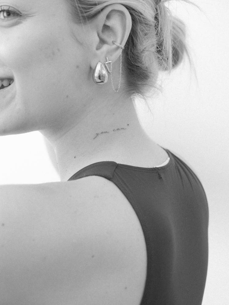 "You can" lettering tattoo in handwritten font placed on the neck.