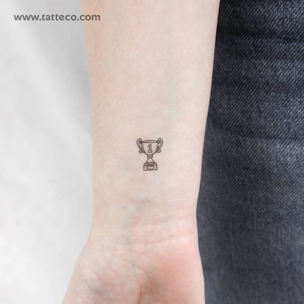 Fine line style trophy temporary tattoo located on the wrist.