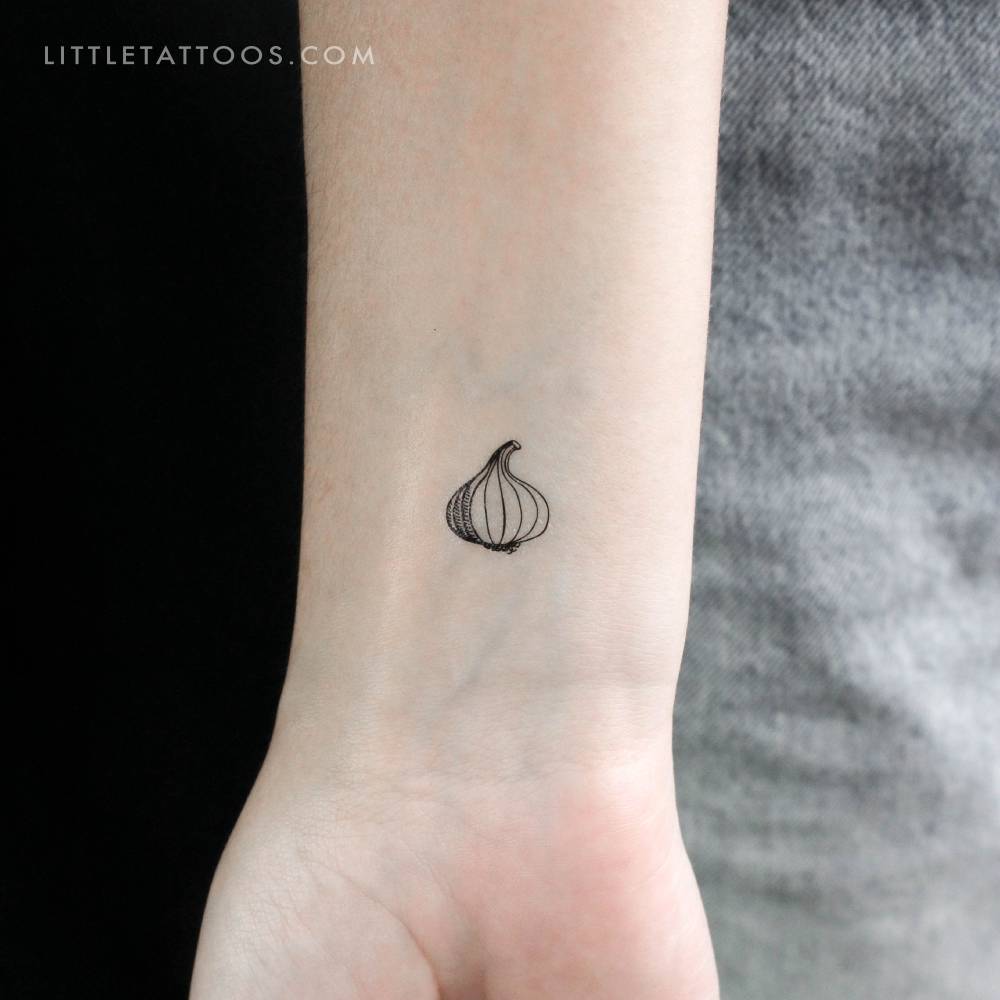 Garlic temporary tattoo in fine line style located on the wrist.
