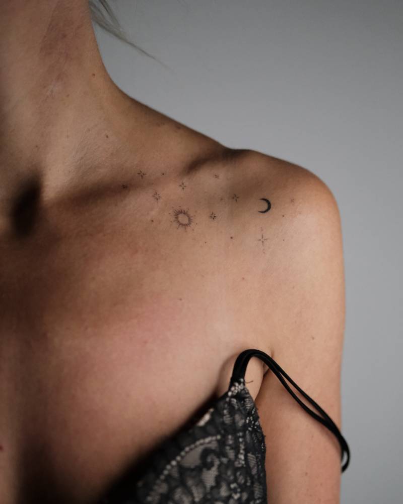 Sun, moon and stars tattoo located on the shoulder.