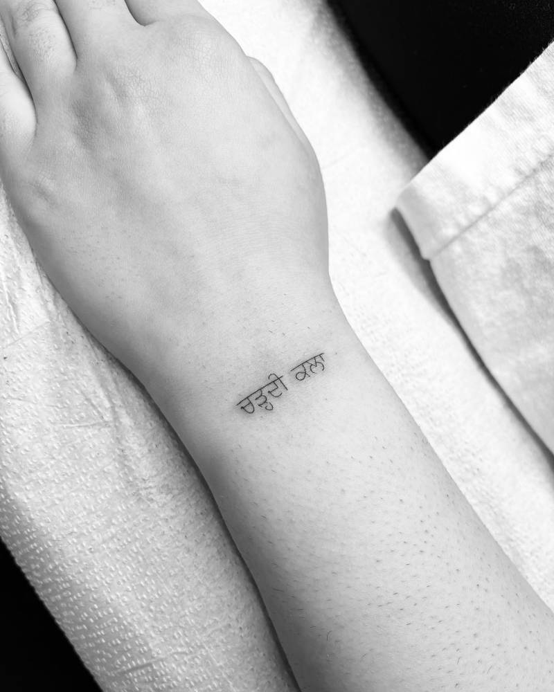 Punjabi lettering tattoo located on the wrist.