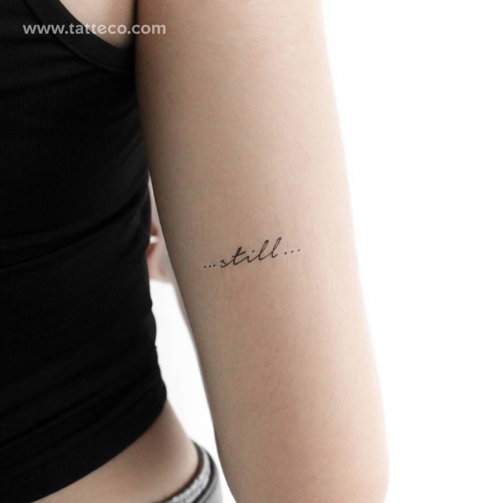 "Still" temporary lettering tattoo located on the tricep.