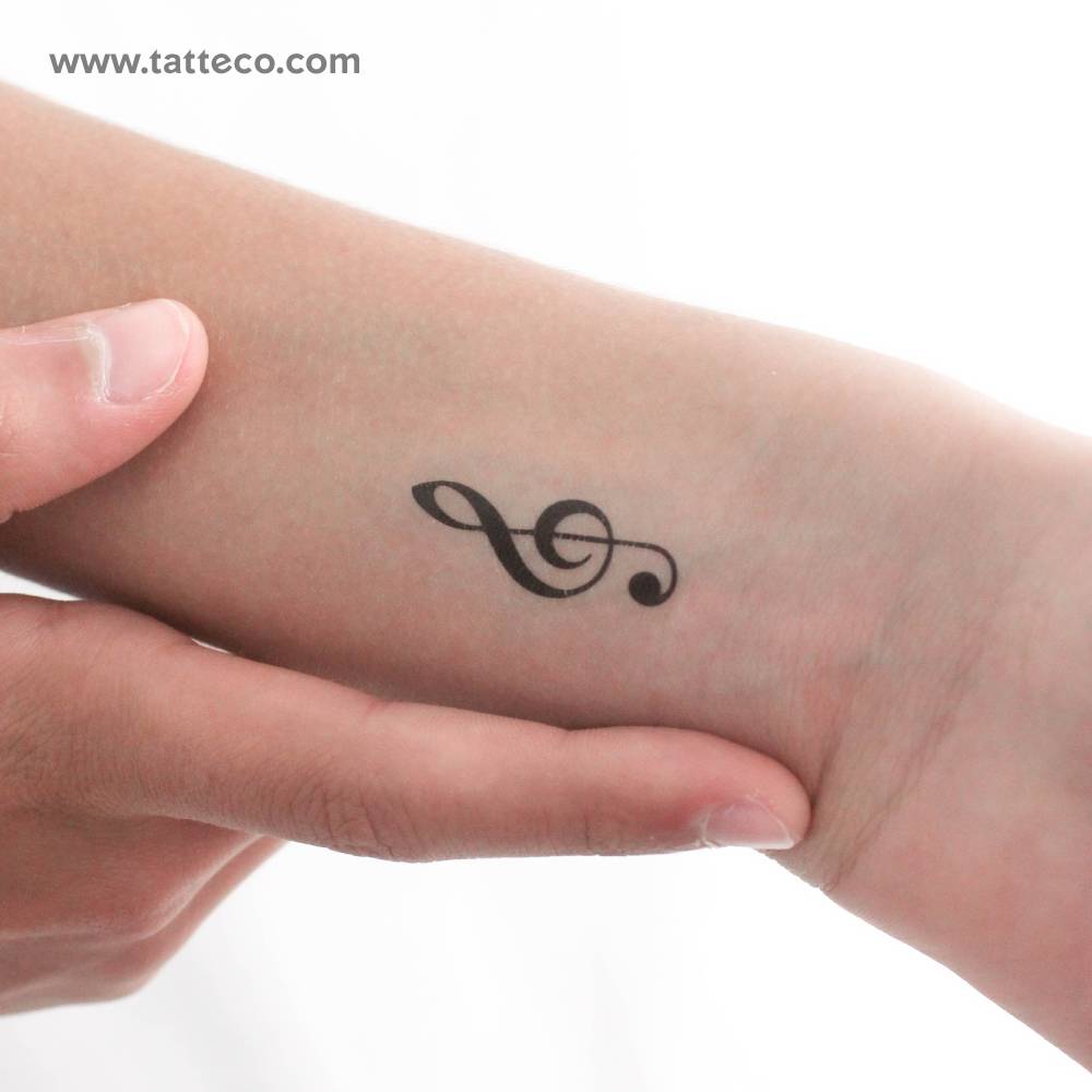 Treble clef temporary tattoo located on the wrist.