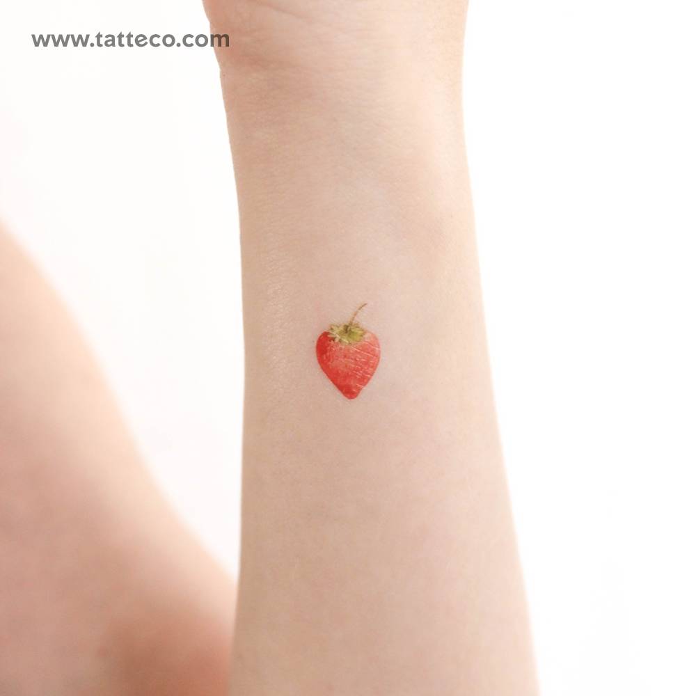 Watercolor style strawberry temporary tattoo done on the wrist.