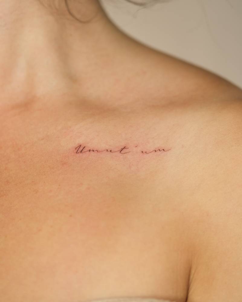 The name of her son tattooed on the collarbone.