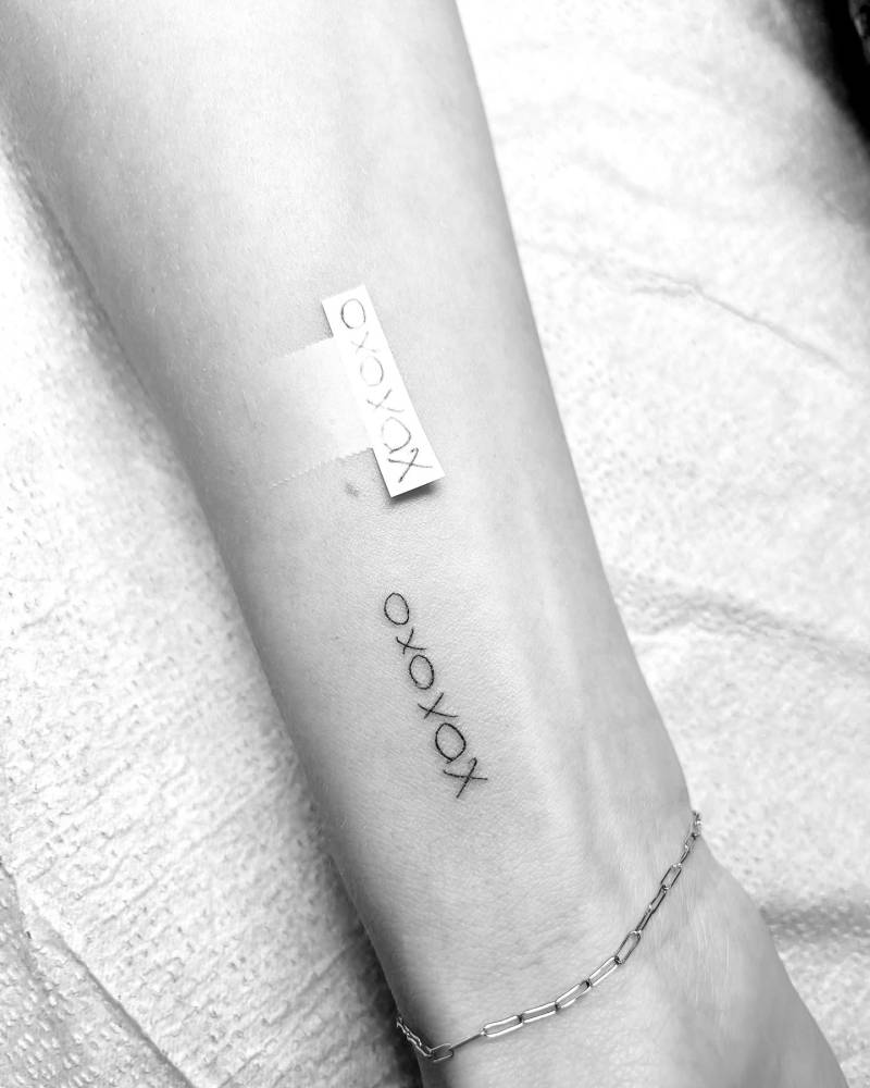"XOXOXO" lettering tattoo located on the wrist.