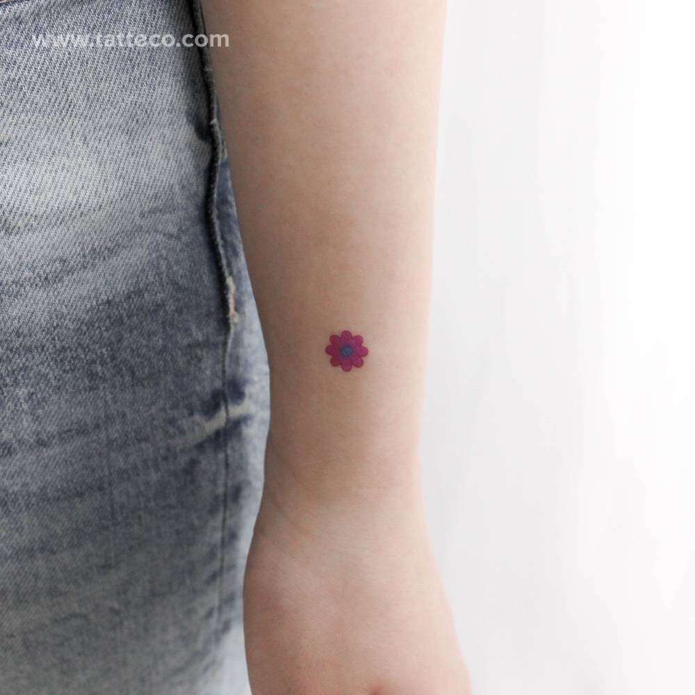 Pink flower temporary tattoo located on the wrist.