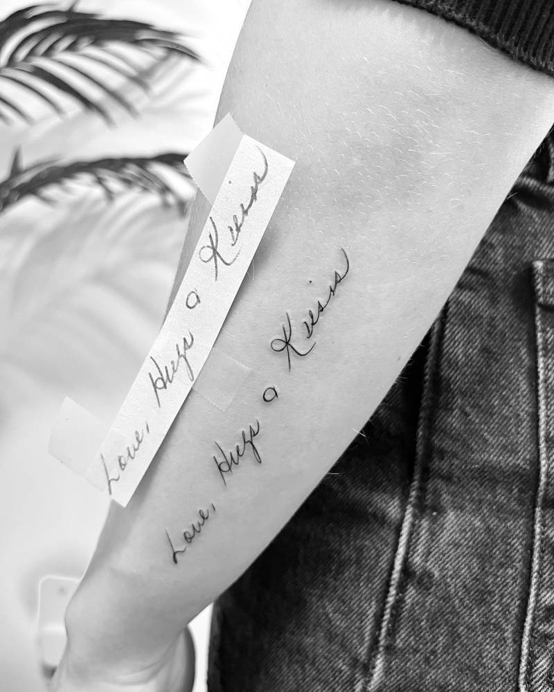"Love, hugs and kisses" tattoo located on the forearm.