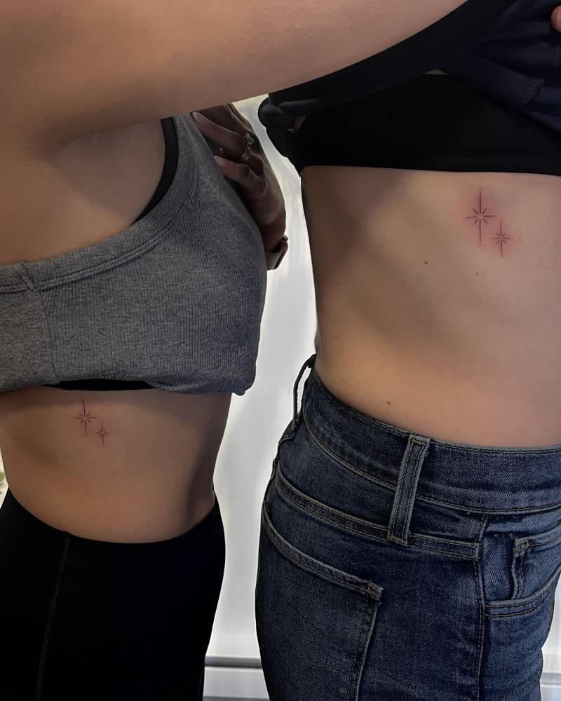 Matching sparkling stars tattoo in fine line style for best friends.