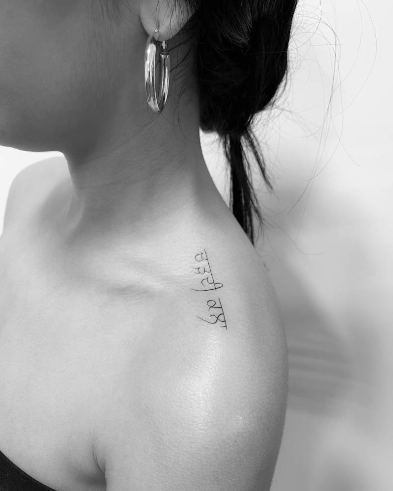 Punjabi lettering tattoo located on the top of shoulder.