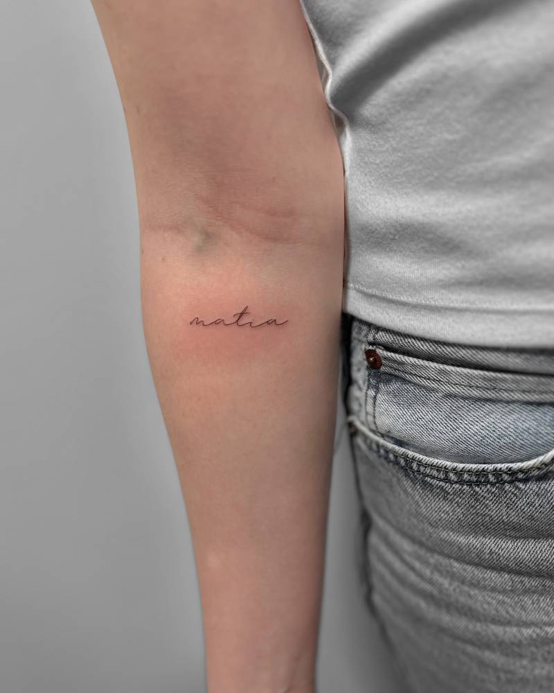 Handwritten font name "Matia" tattooed on the inner forearm.