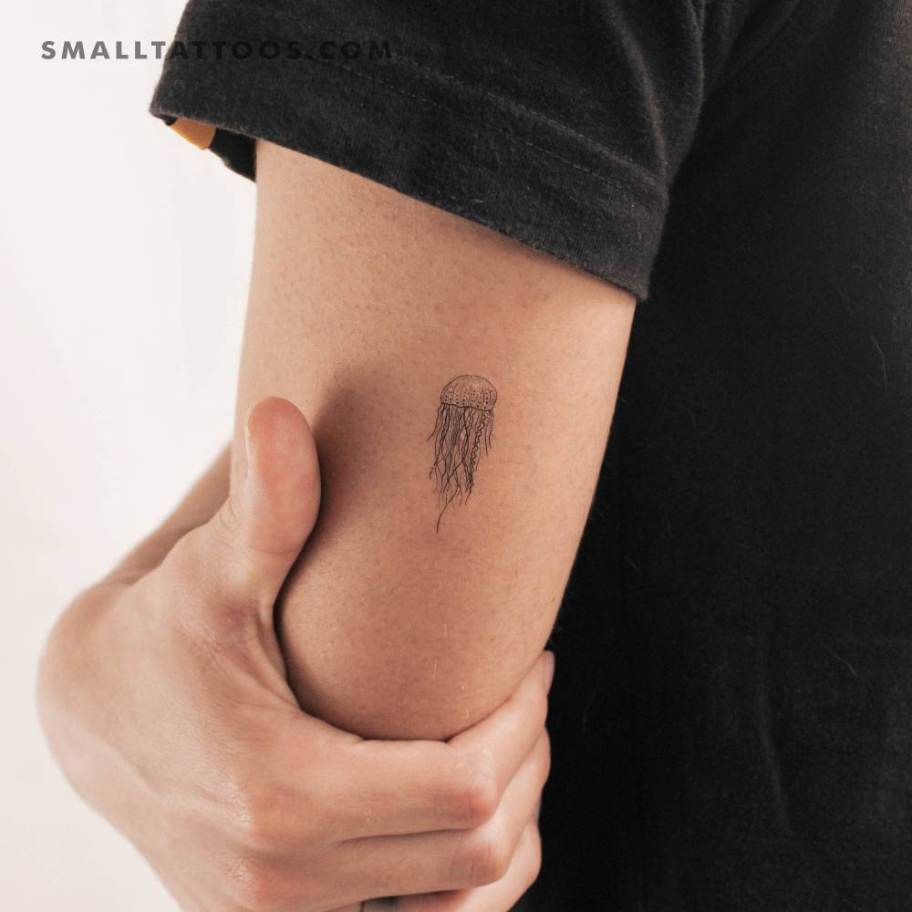 Illustrative style jellyfish temporary tattoo located on the tricep.