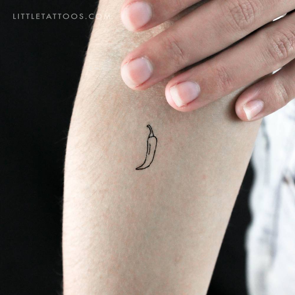 Little fine line chili temporary tattoo located on the inner forearm.