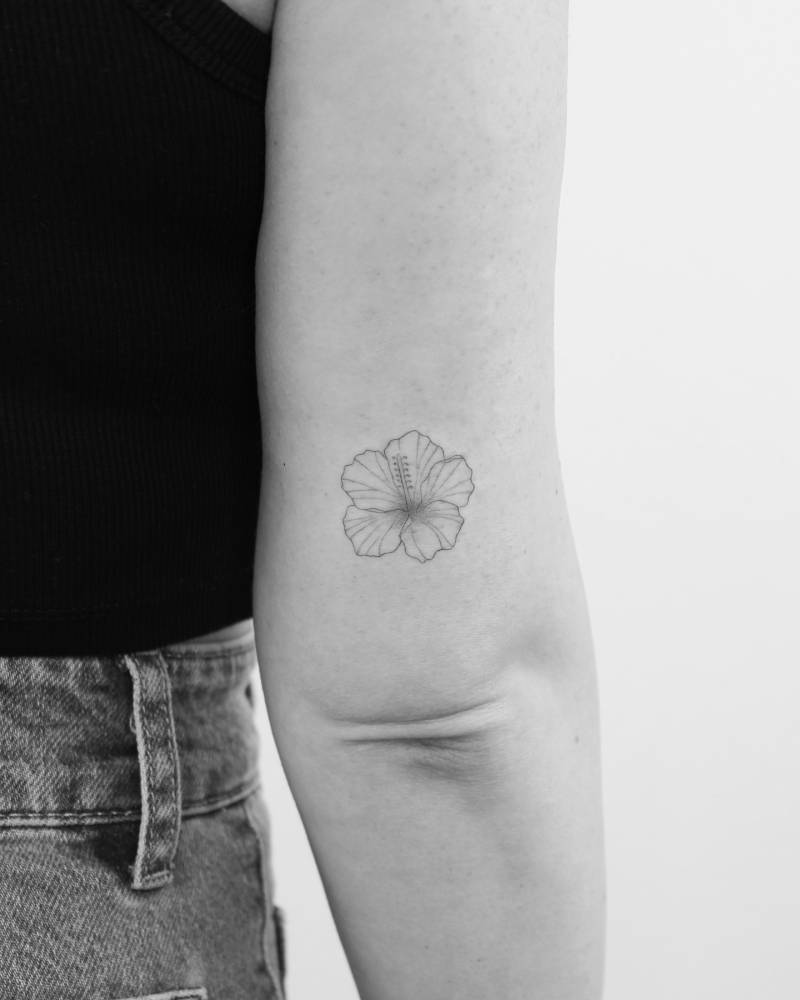 Hibiscus flower tattoo located on the tricep.