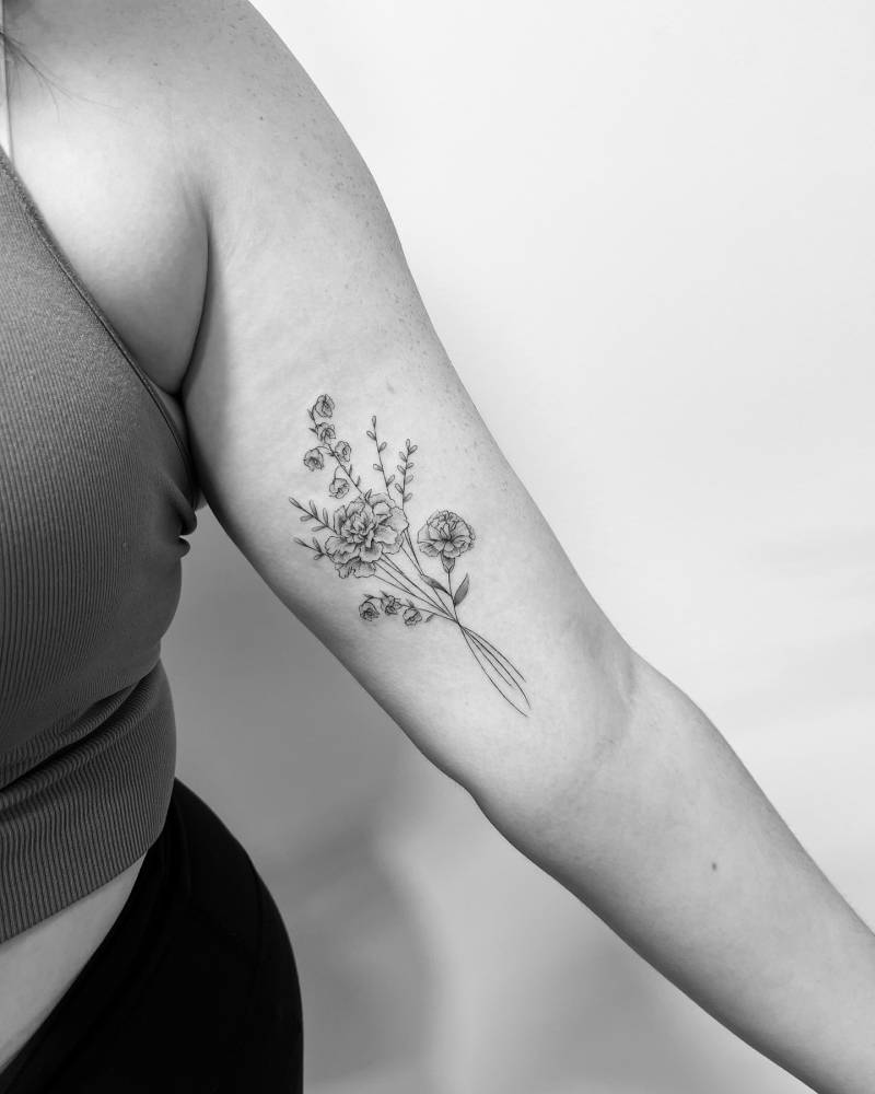 Flower bouquet tattoo in illustrative style located on the inner arm.