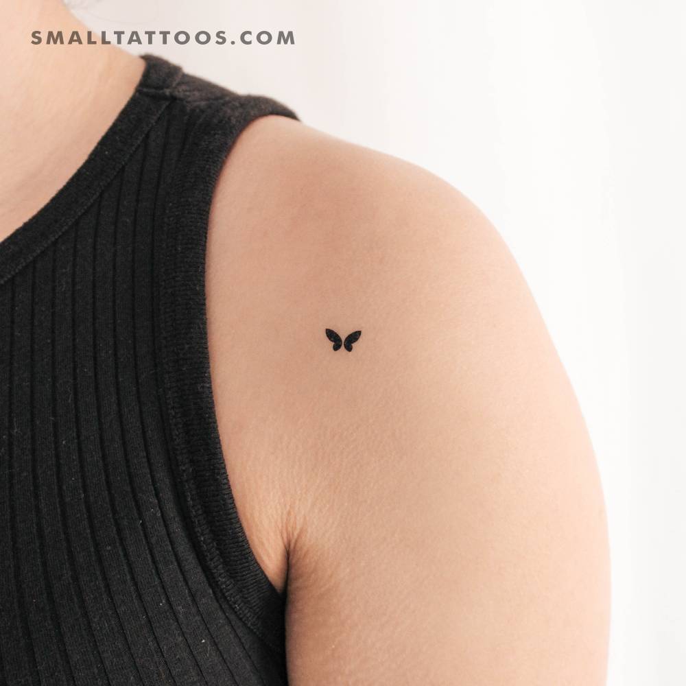 Tiny Minimalistic butterfly temporary tattoo located on the shoulder.
