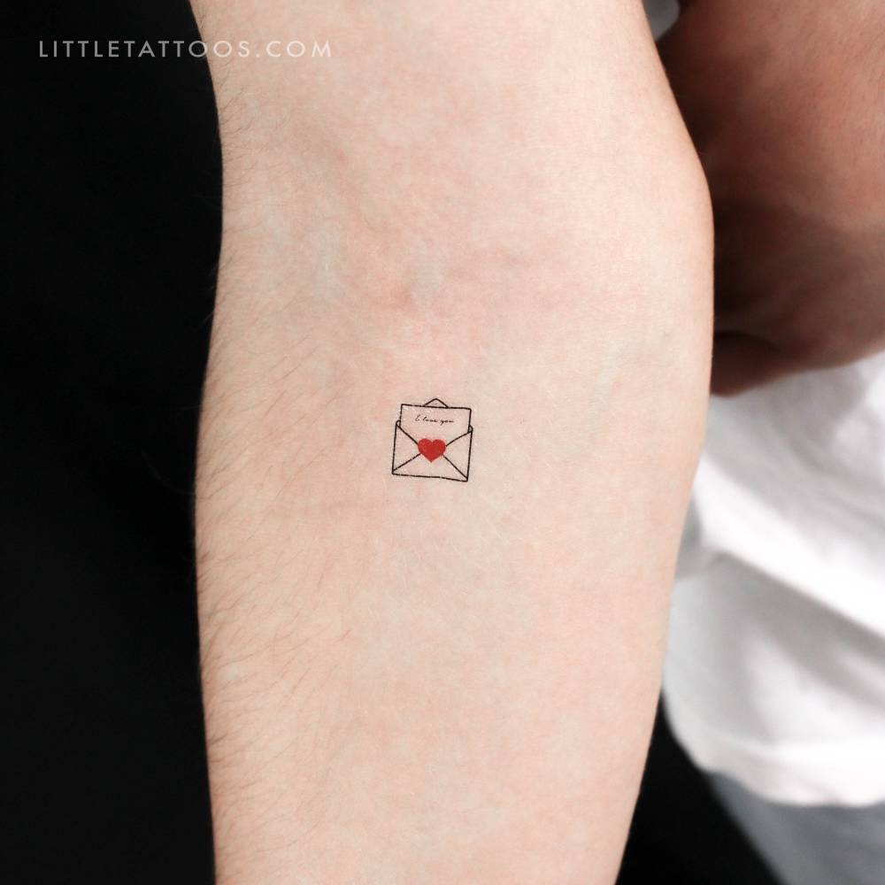 Open love letter temporary tattoo placed on the inner forearm.