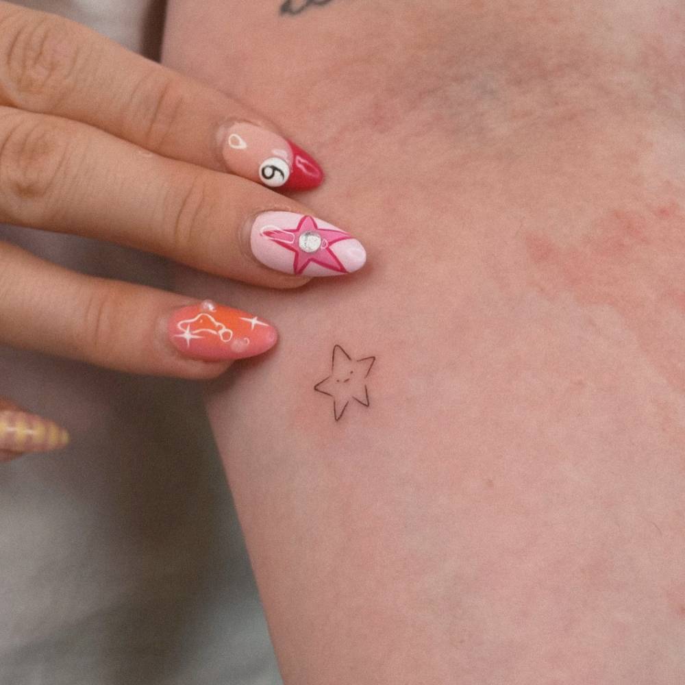 Tiny minimalistic star tattoo located on the inner forearm.