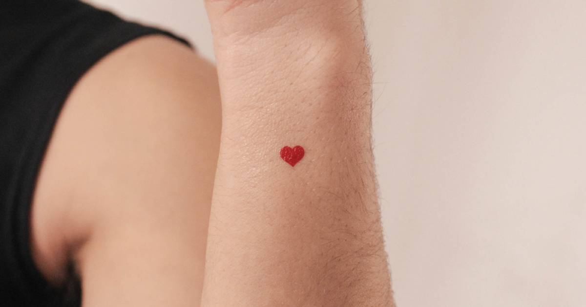 Small minimalistic red heart temporary tattoo done on