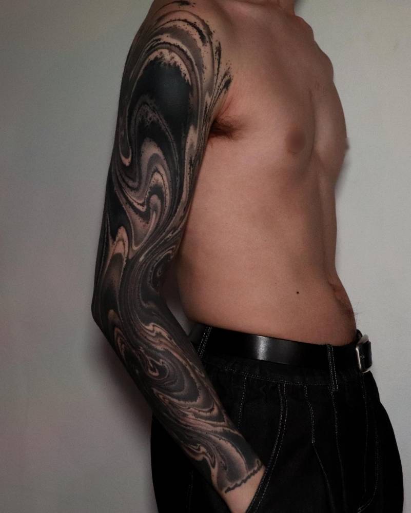 Abstract tattoo sleeve done in blackwork style.
