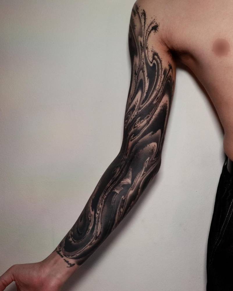 Abstract tattoo sleeve done in blackwork style.
