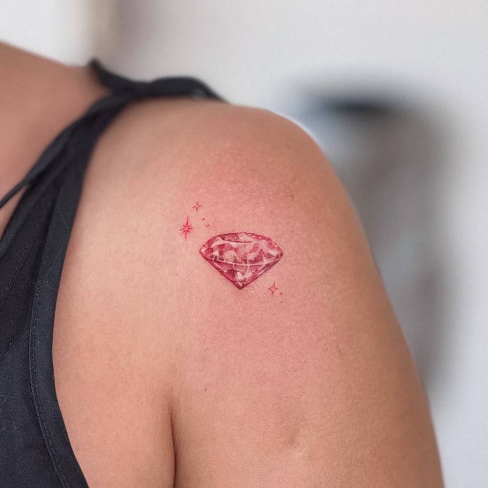 Illustrative style ruby tattoo located on the shoulder.