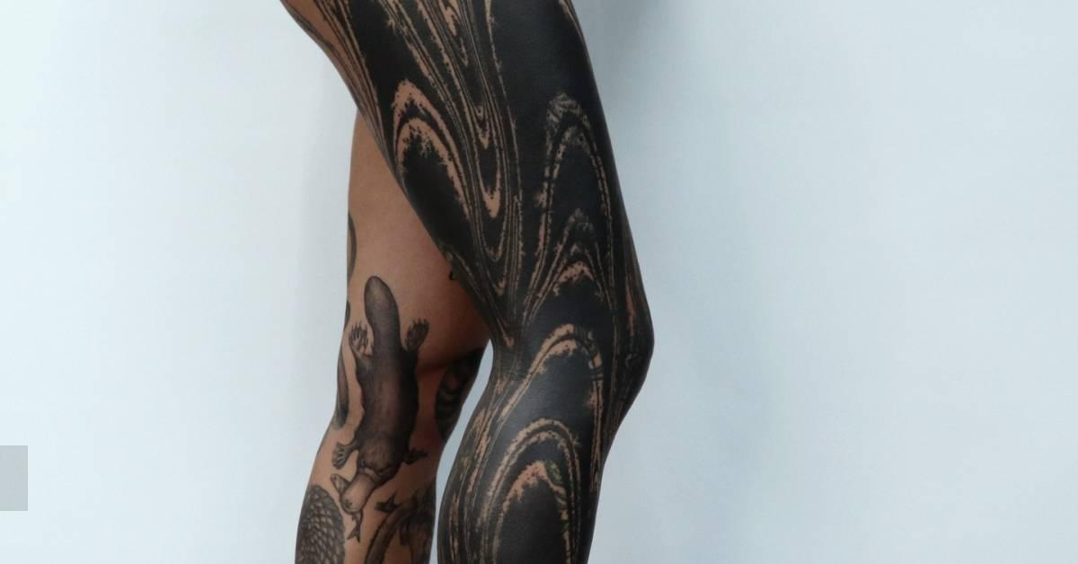 Blackwork style abstract leg sleeve tattoo.