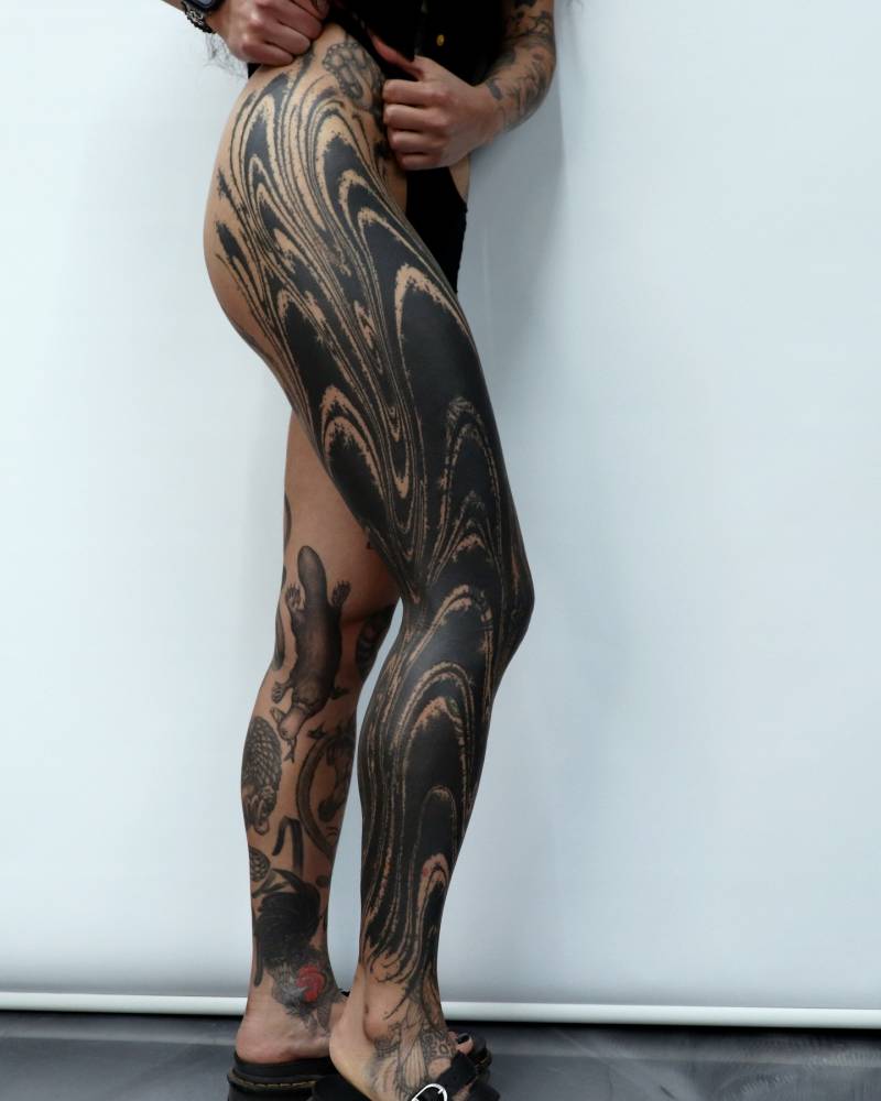 Blackwork style abstract leg sleeve tattoo.