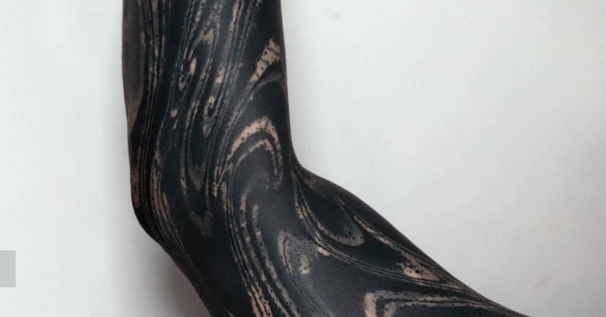 Abstract sleeve tattoo in blackwork style.