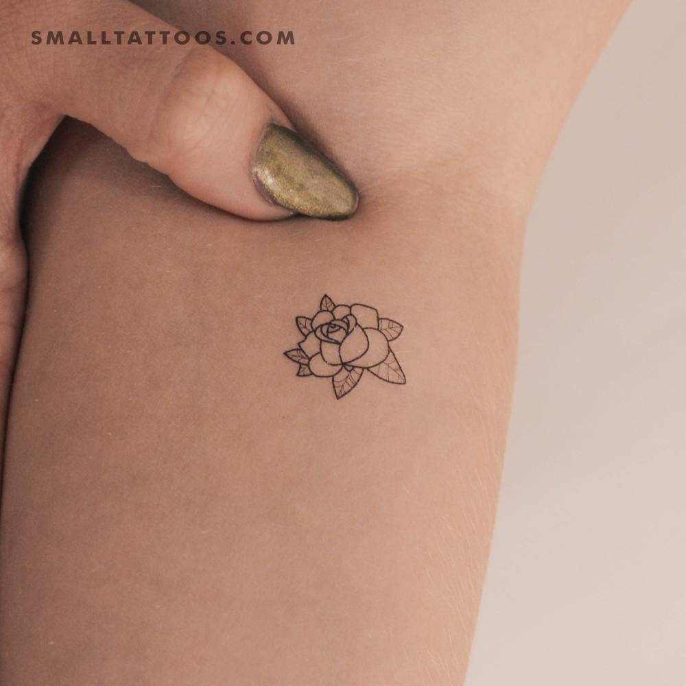 Rose head outline temporary tattoo located on the inner forearm.